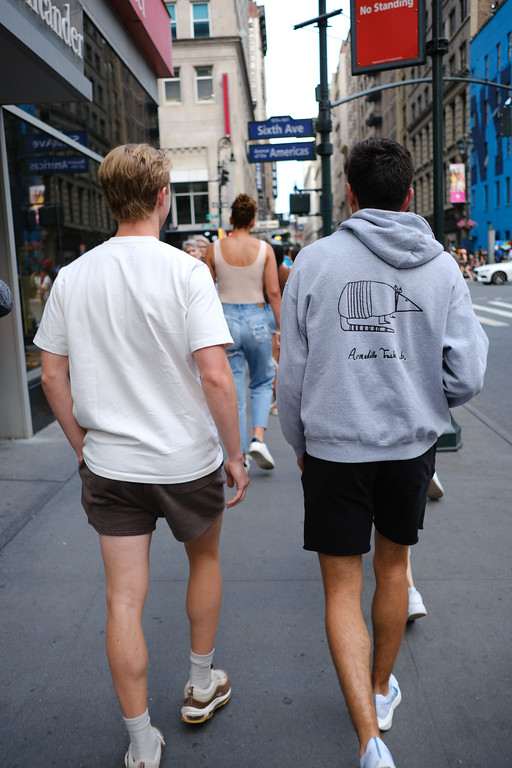 Friends walking together along a city sidewalk
