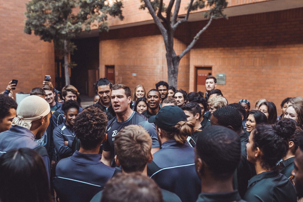 An athlete surrounded by a lively crowd outdoors