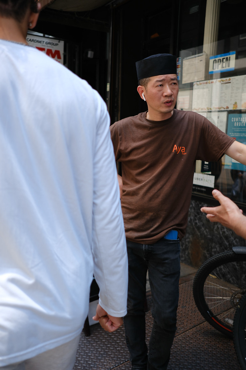 A candid conversation outside a city storefront