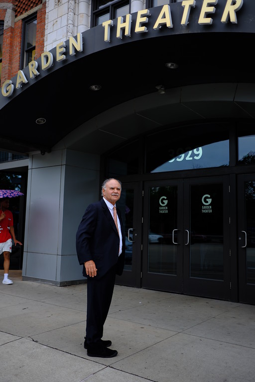 A man standing outside the Garden Theater entrance